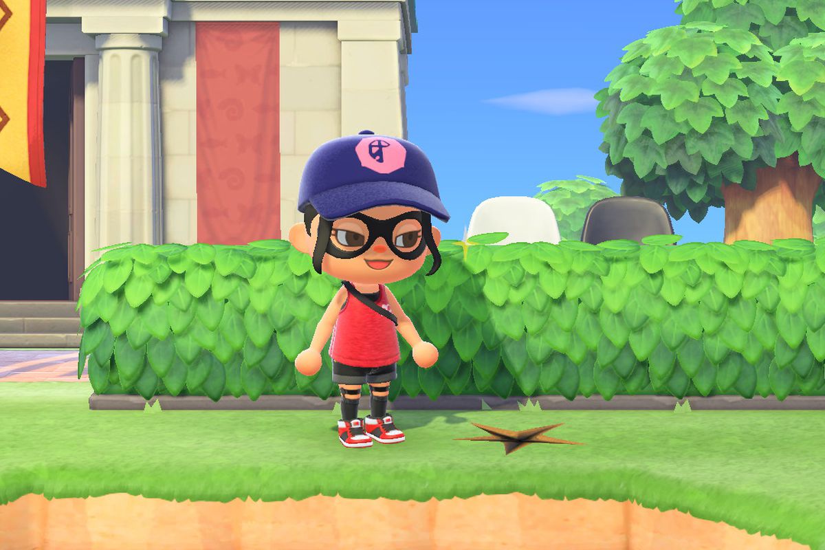 An Animal Crossing character smiles in front of some hedges
