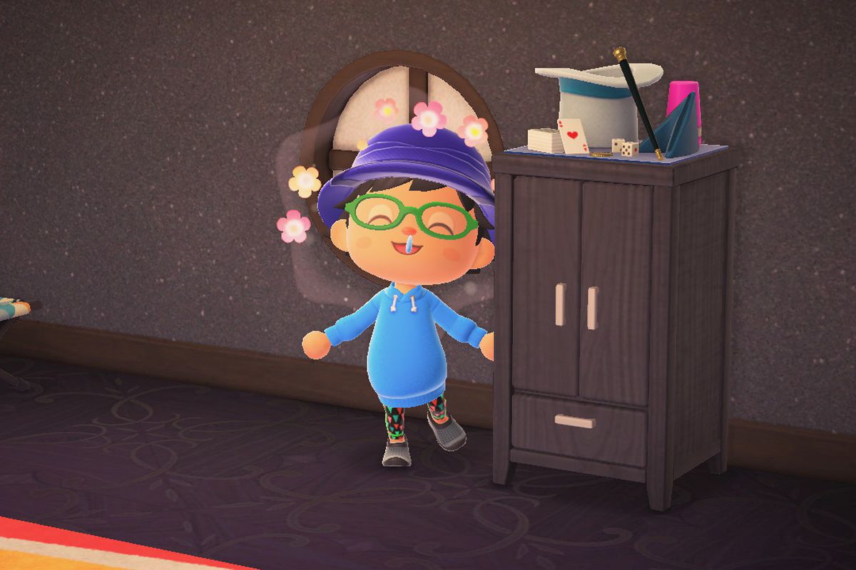 A happy villager stands next to a black dresser in Animal Crossing: New Horizons